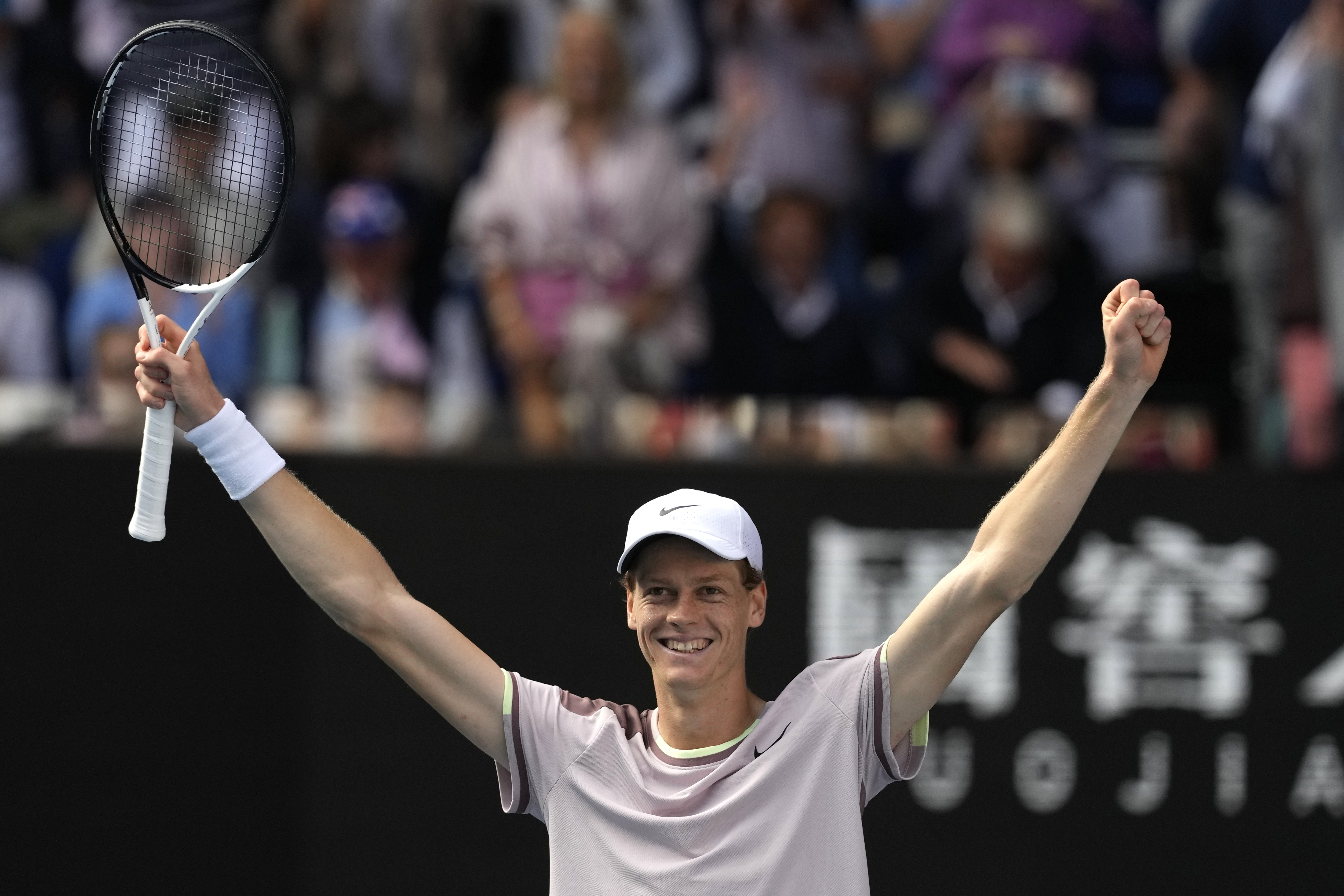 Jannik Sinner celebrates beating Novak Djokovic