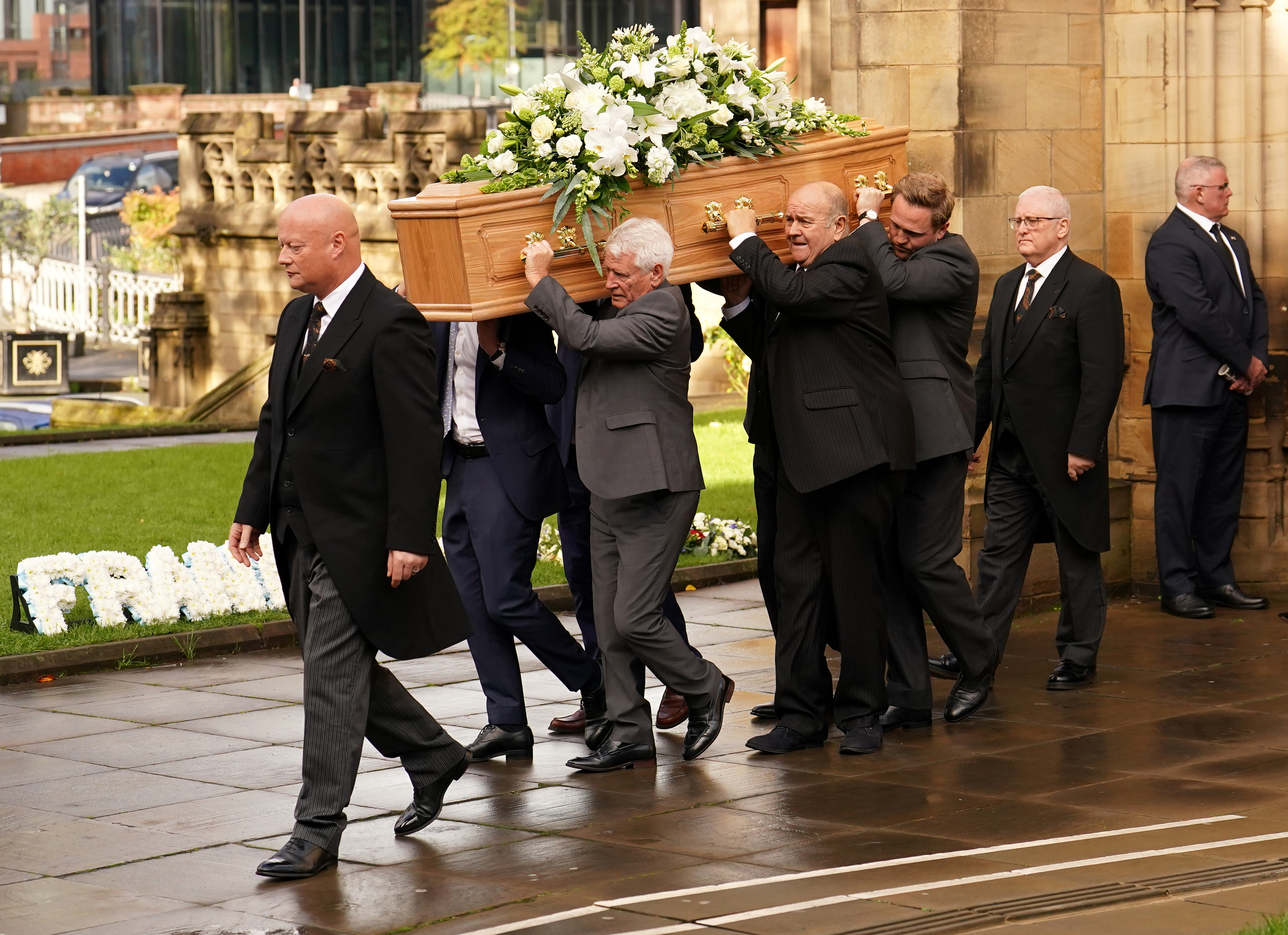 Francis Lee's coffin is carried from the church following his funeral service at Manchester Cathedral