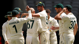 Nathan Lyon celebrates after taking the wicket of Roston Chase