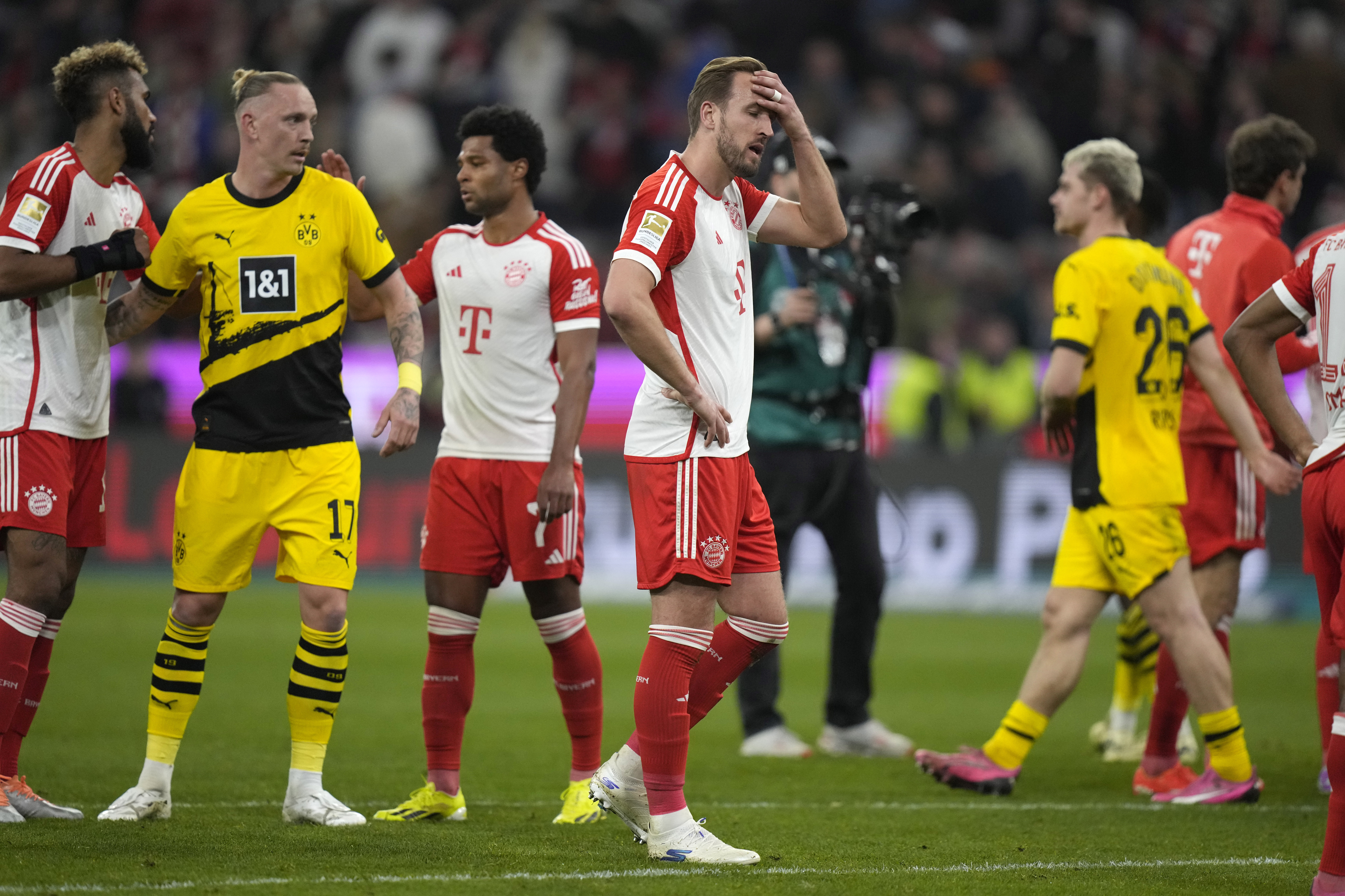 Harry Kane, centre, saw his Bayern Munich side slip 13 points adrift of Bundesliga leaders Bayer Leverkusen (Matthias Schrader/AP)