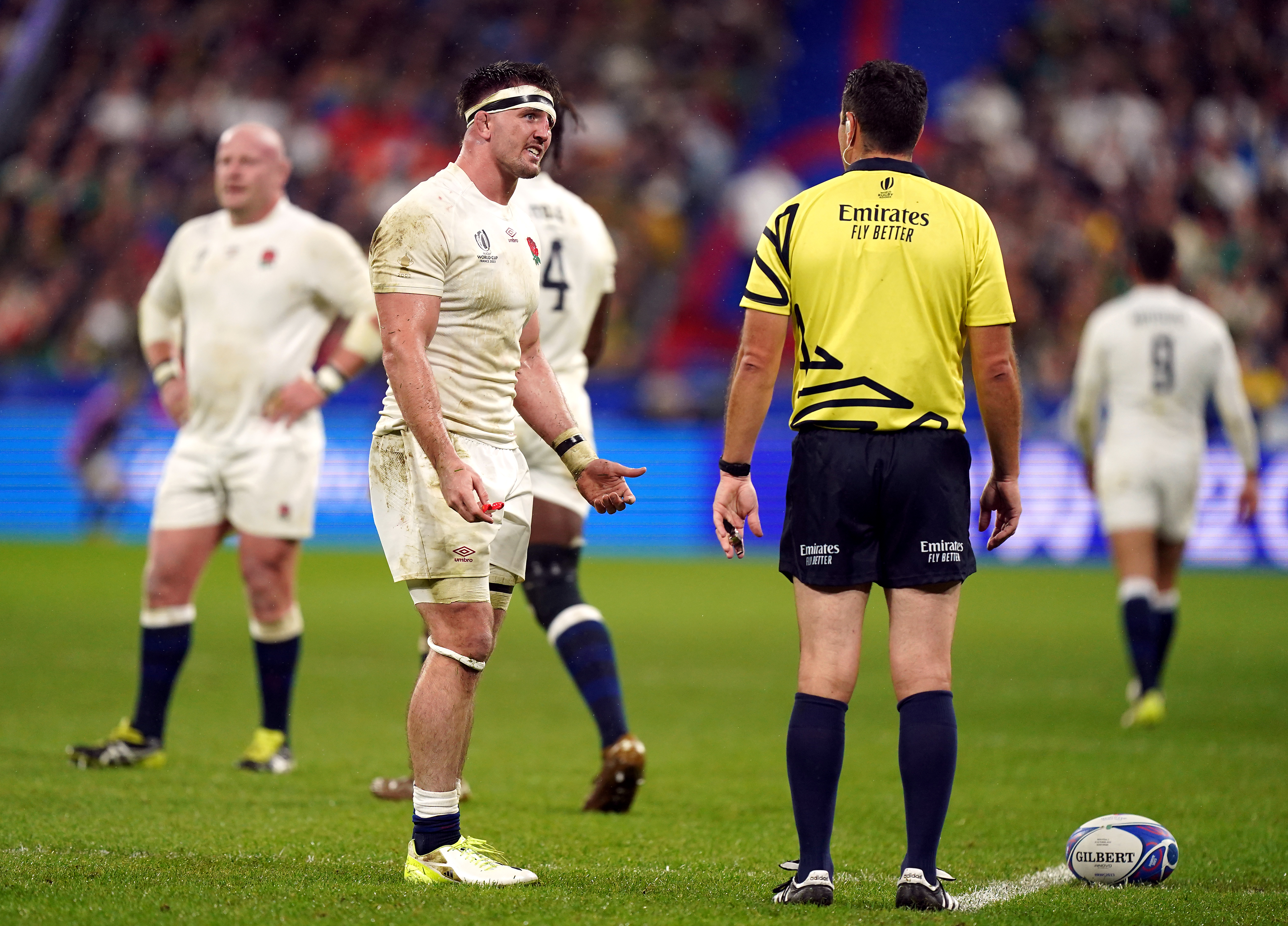 Tom Curry, left, speaks to referee Ben O’Keeffe