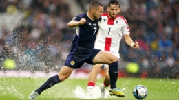 Scotland’s John McGinn deals with the conditions (Andrew Milligan/PA)