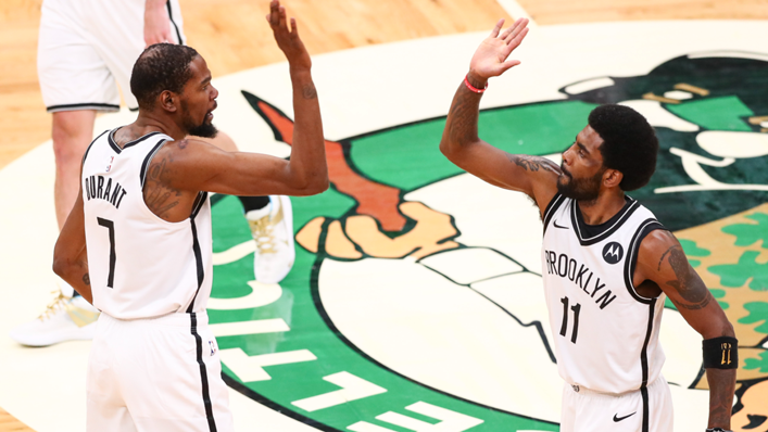 Kevin Durant high fives Kyrie Irving of the Brooklyn Nets
