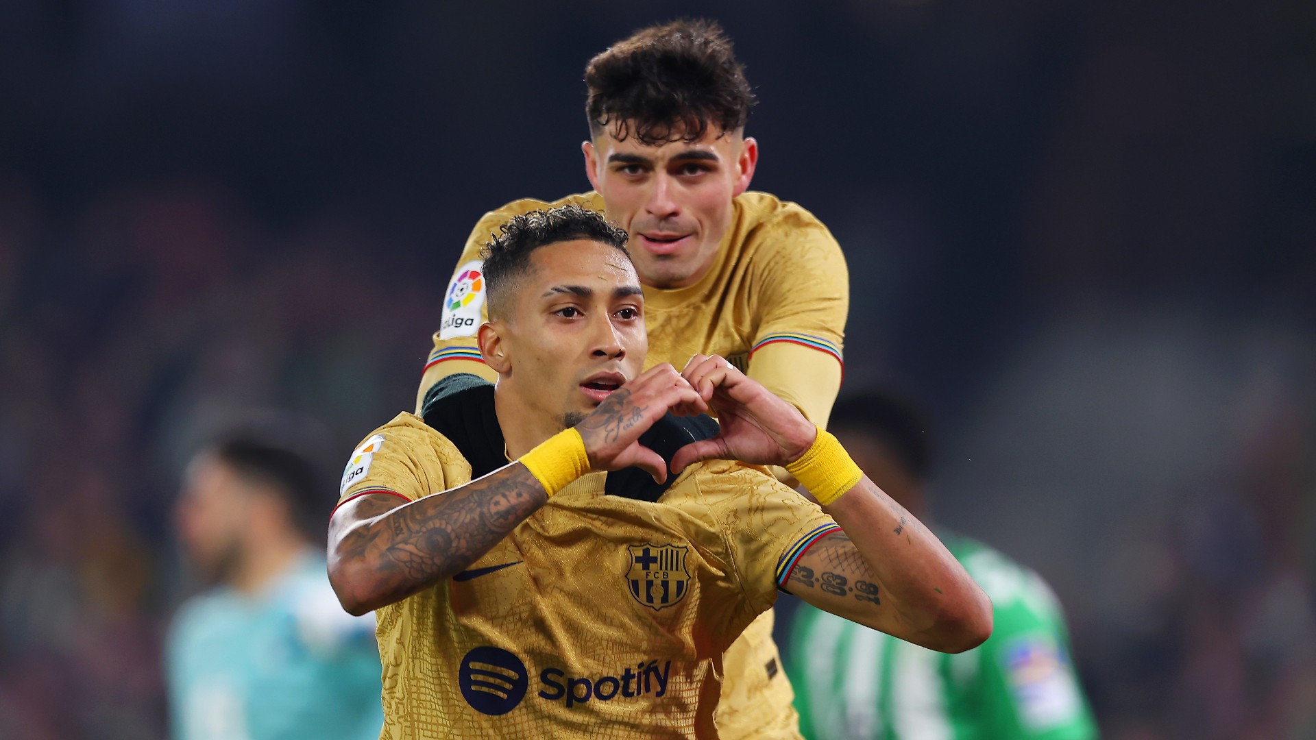 Raphinha celebrates with Pedri after scoring against Real Betis