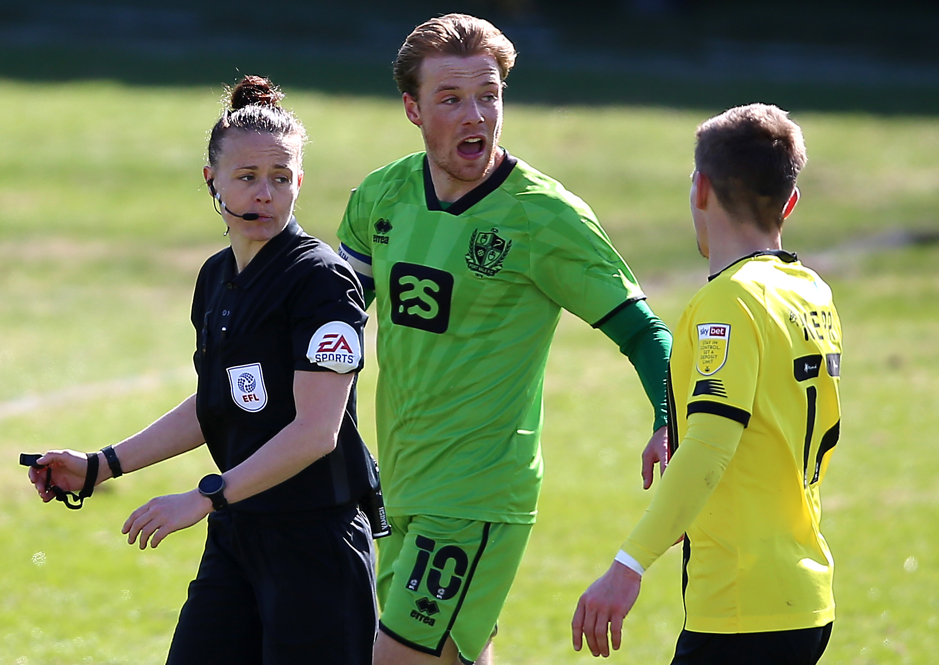 Referee Rebecca Welch (left) speaks with Port Vale’s Tom Conlon and Harrogate Town’s Lloyd Kerry (right)