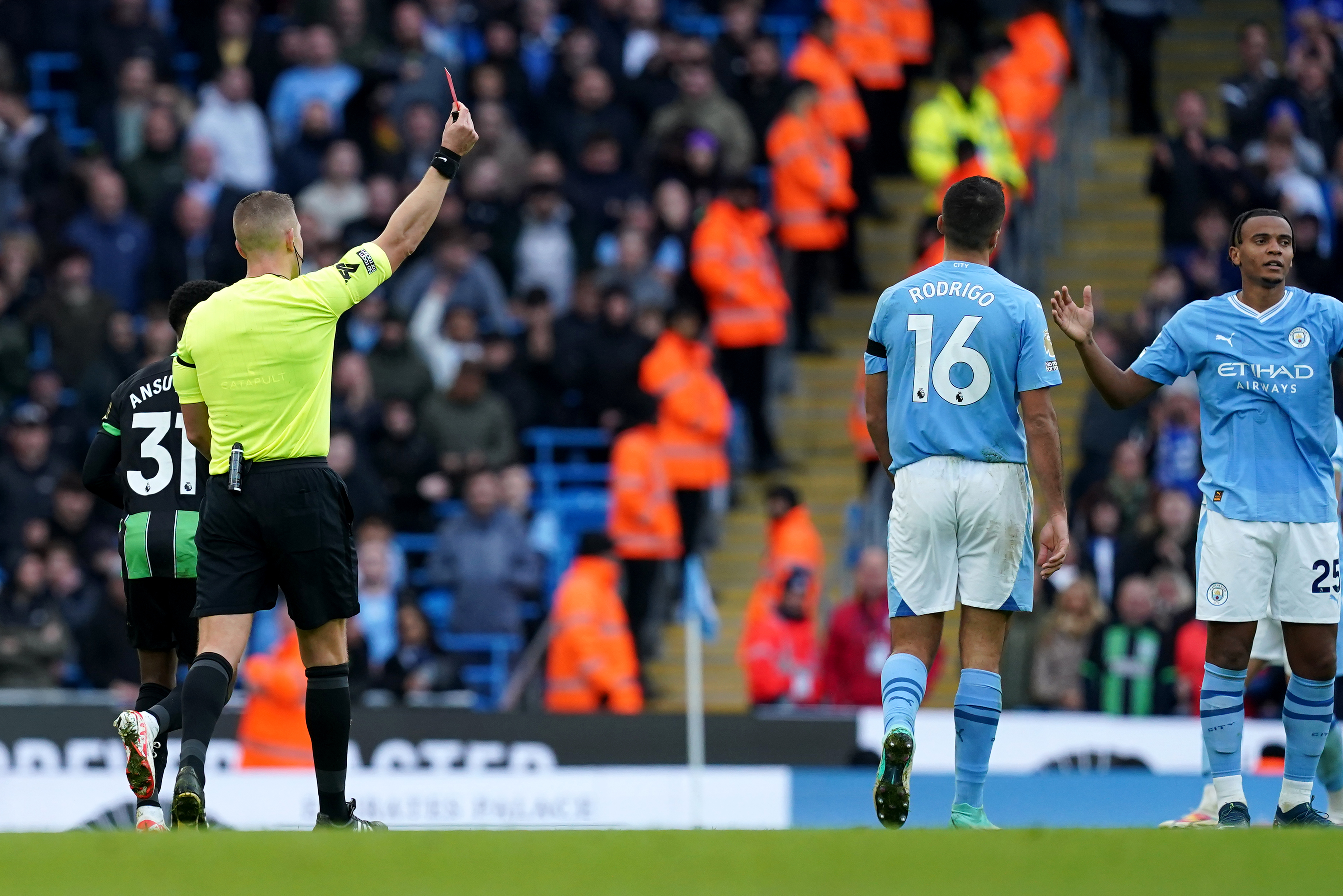Manuel Akanji, right, is shown a red card against Brighton