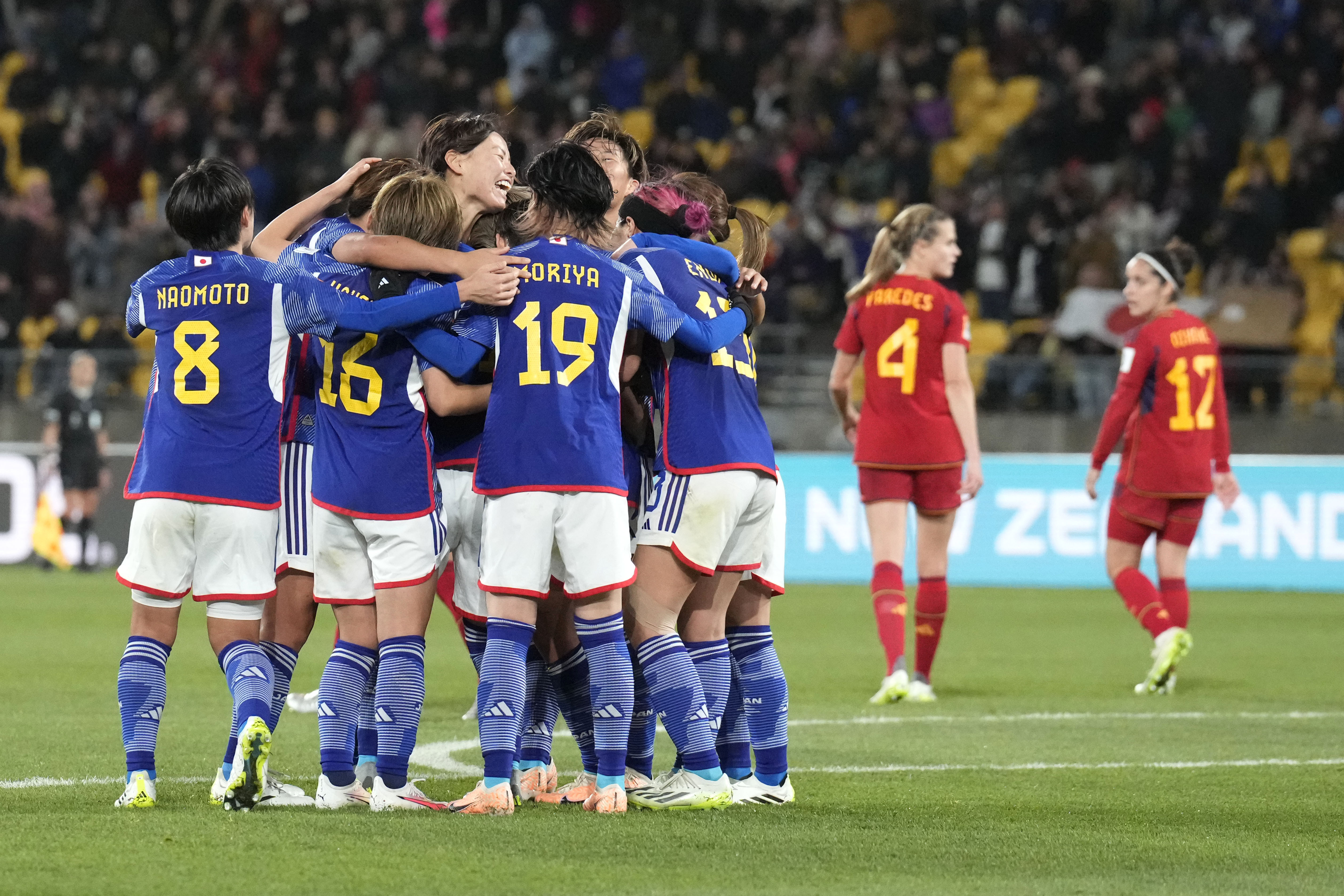 Japan’s Mina Tanaka celebrates with team-mates after scoring against Spain