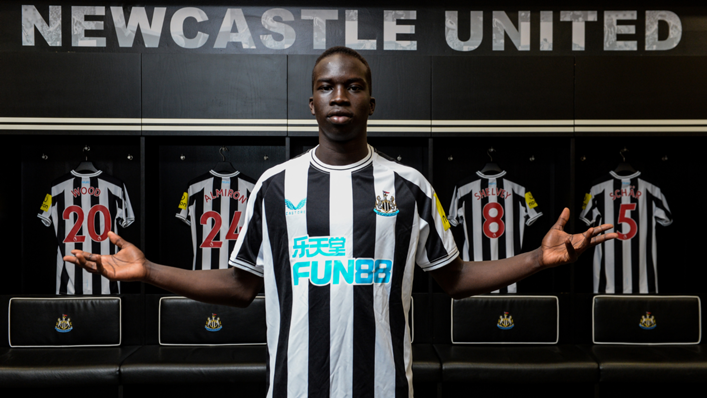 Garang Kuol poses for photographs in the dressing room at St James' Park