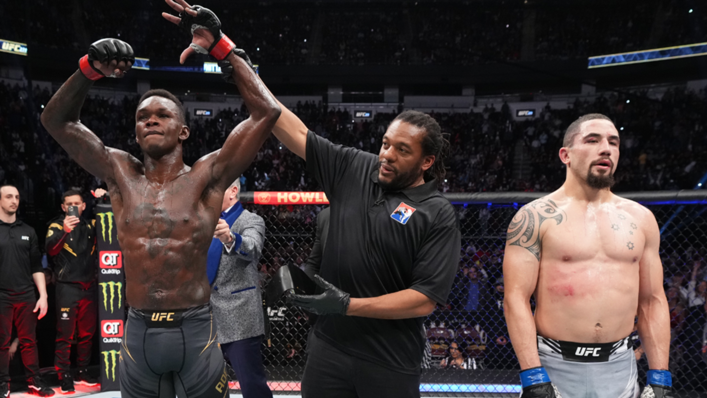 Israel Adesanya of Nigeria reacts after defeating Robert Whittaker of Australia by unanimous decision in their UFC middleweight championship fight during UFC 271