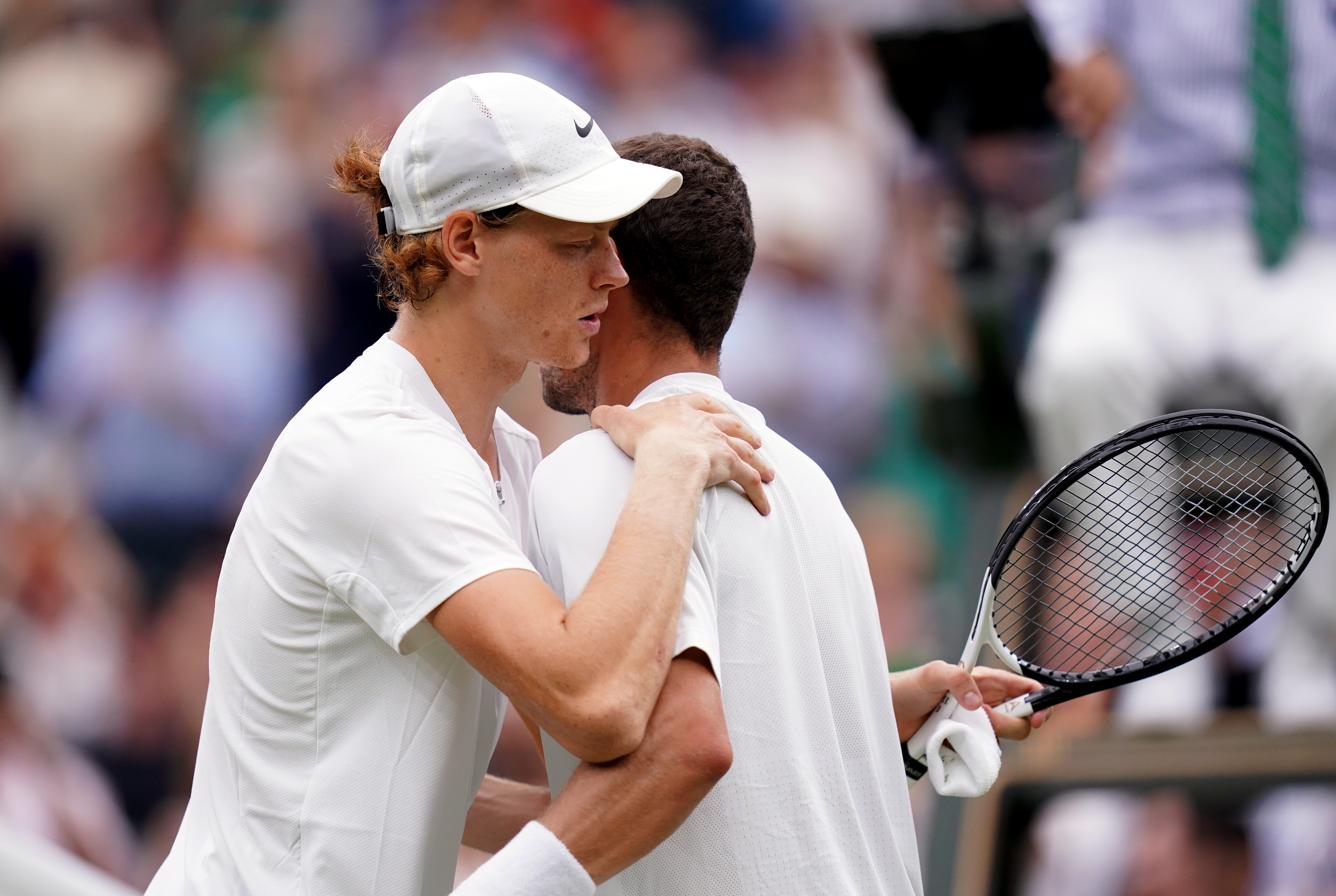 Jannik Sinner, left, shakes hands with Roman Safiullin