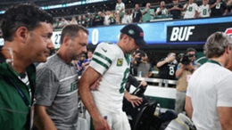 New York Jets quarterback Aaron Rodgers is helped to the locker room