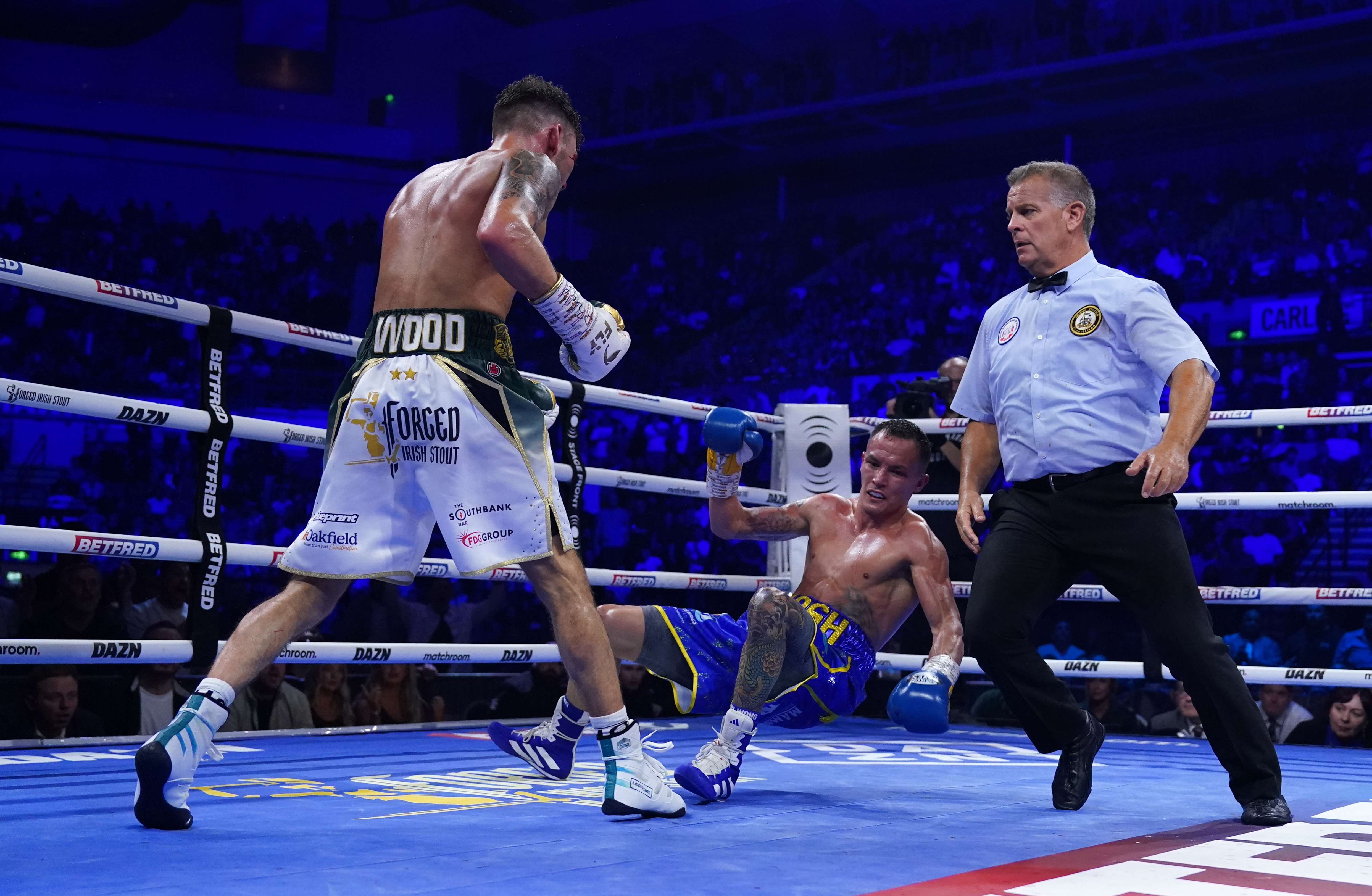 Leigh Wood, left, stopped Josh Warrington in round seven to retain his WBA featherweight title in Sheffield after being dominated for most of the fight (