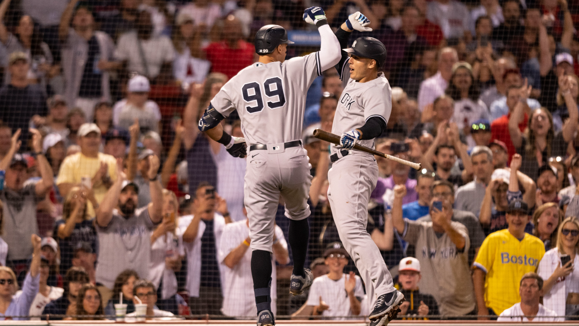 Aaron Judge of the New York Yankees reacts with Anthony Rizzo #48 after hitting a solo home run during the third inning of a game against the Boston Red Sox