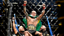 Charles Oliveira of Brazil reacts after being announced the winner by submission against Dustin Poirier after their UFC lightweight championship bout during the UFC 269