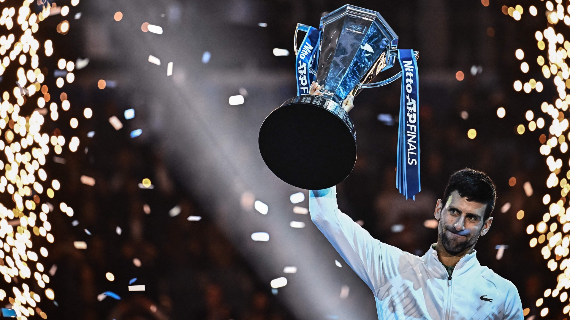 Novak Djokovic holds up the ATP Finals trophy