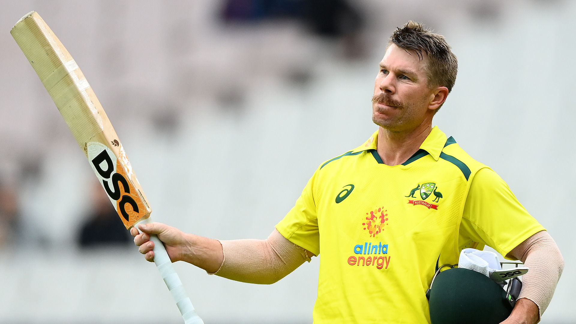 David Warner raises his bat after being dismissed for a fine century at the MCG