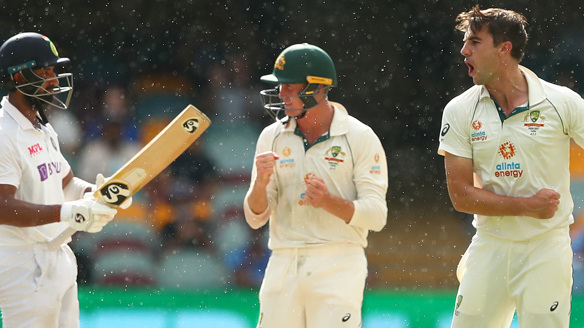 Australia captain Pat Cummins (right) celebrates dismissing Cheteshwar Pujara