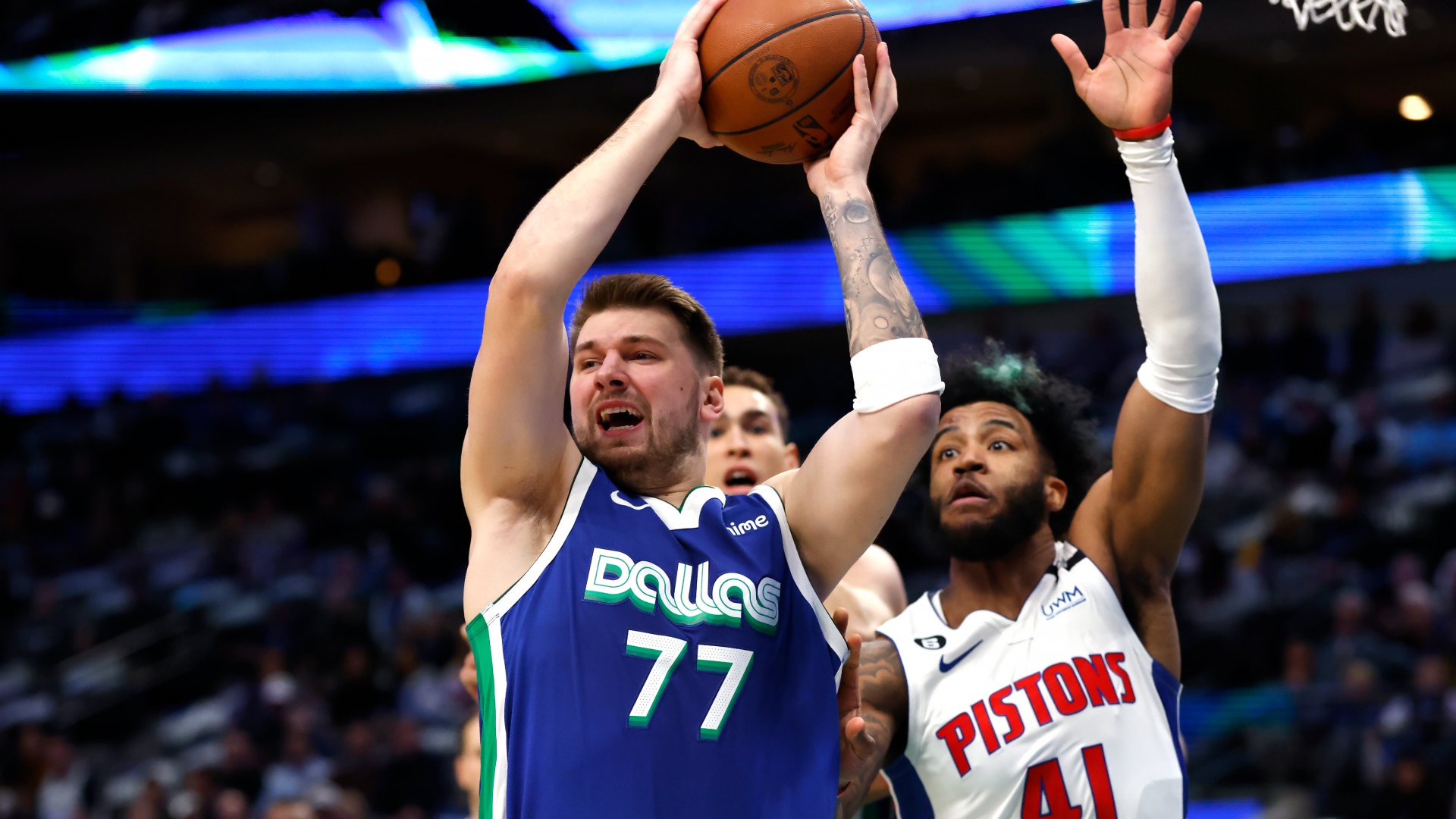 Luka Doncic grabbing one of his eight rebounds against the Pistons