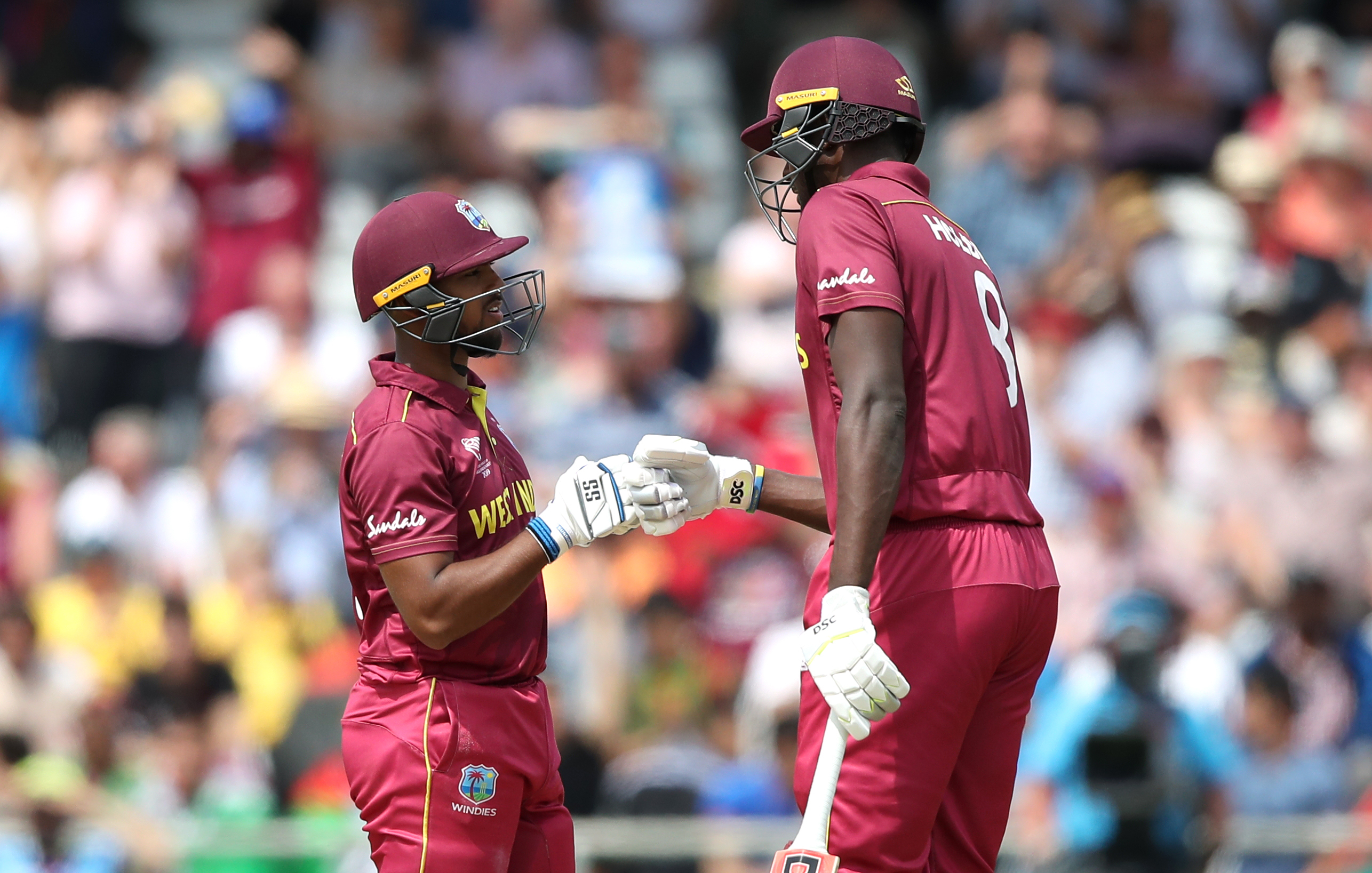 Nicholas Pooran, left, and Jason Holder
