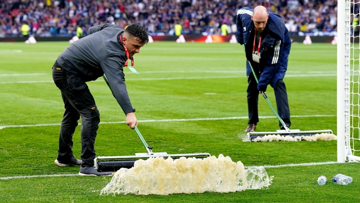 Ground staff had to clear water from the Hampden pitch (Jane Barlow/PA)