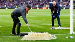 Ground staff had to clear water from the Hampden pitch (Jane Barlow/PA)