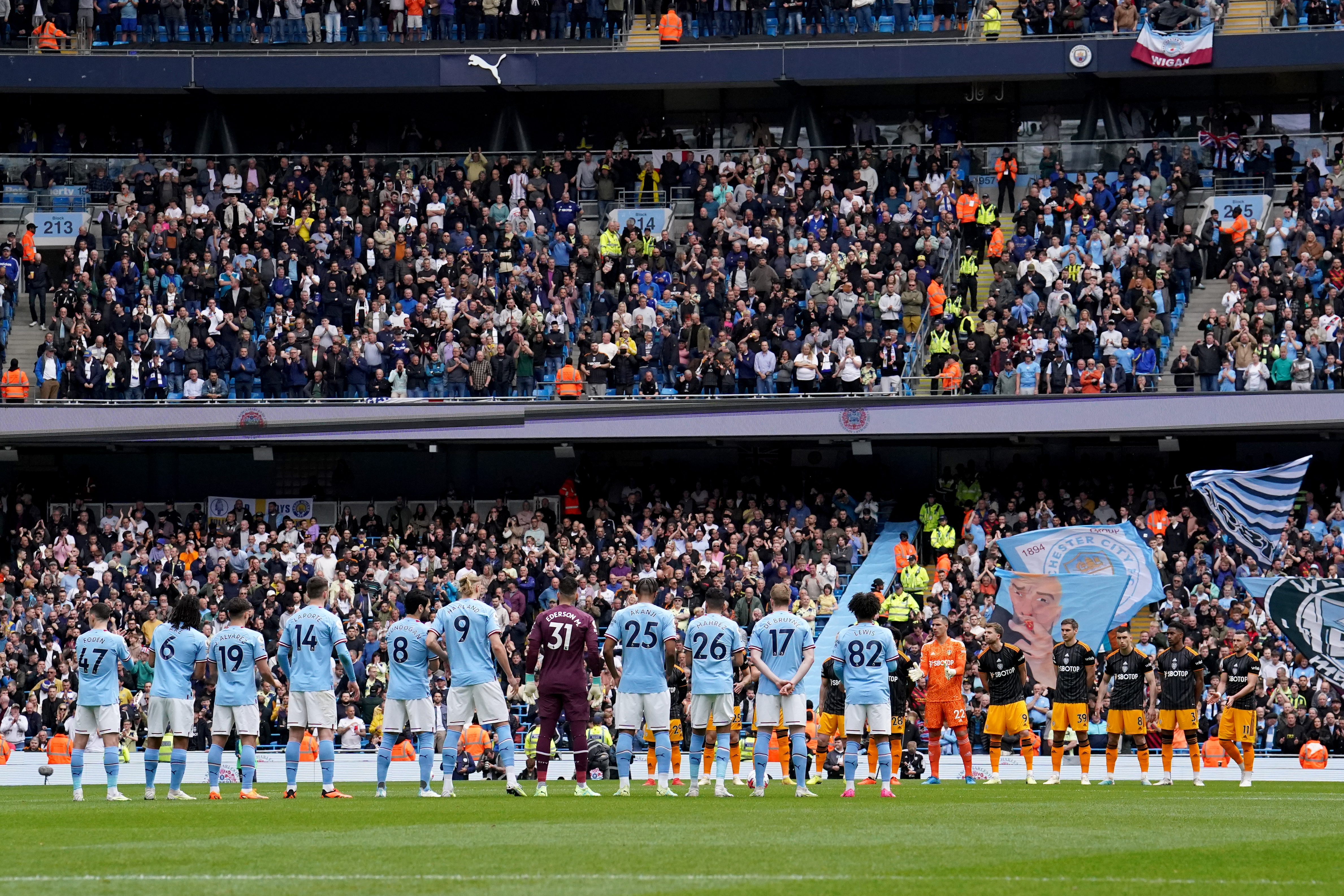 Players from Manchester City and Leeds stood in the centre circle for the national anthem