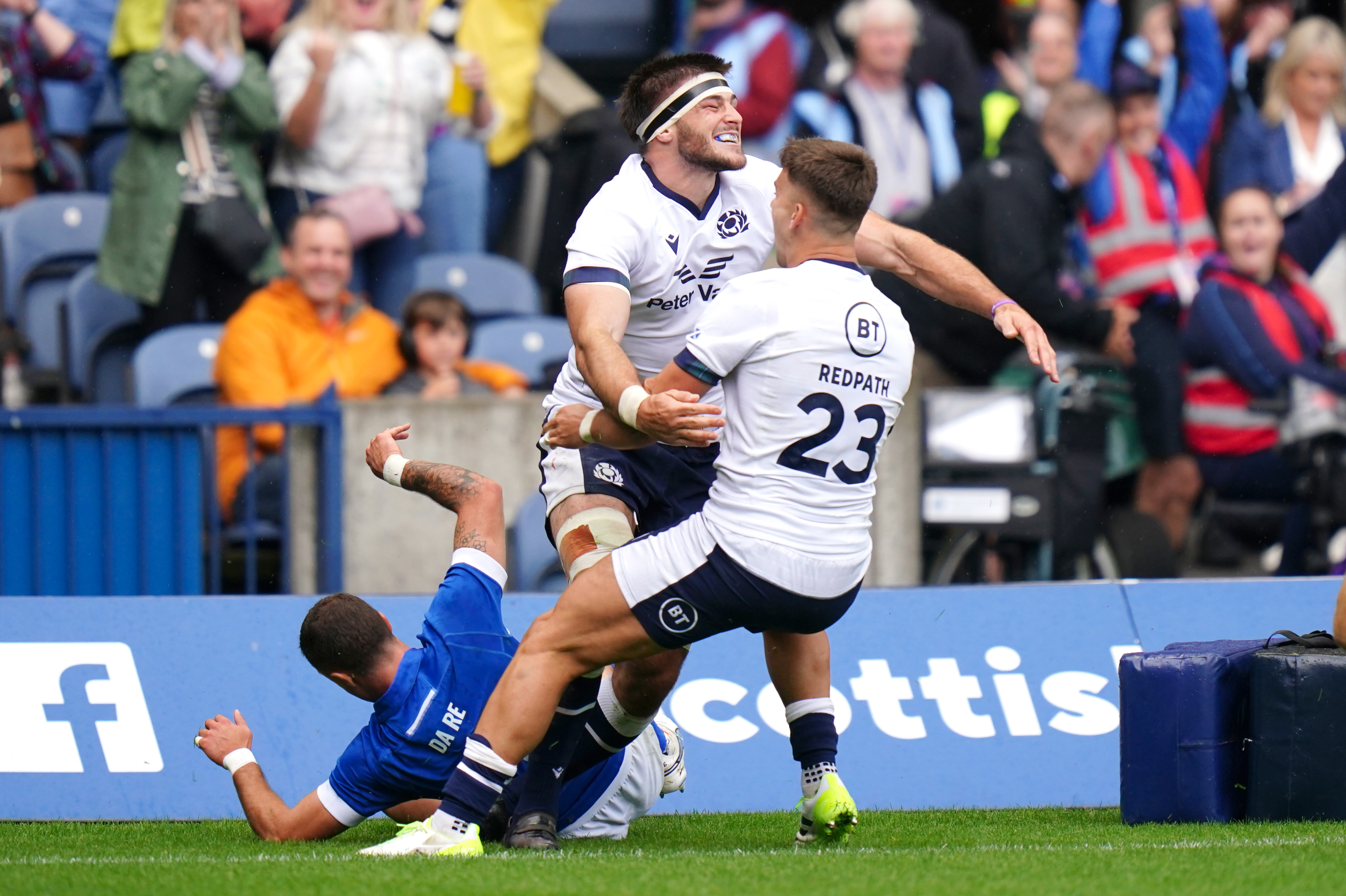 Josh Bayliss (centre) celebrates after sealing the victory for Scotland