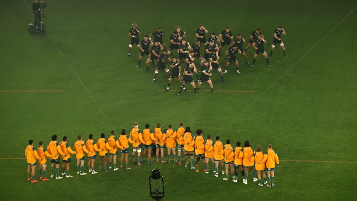 Australia's players watch on as New Zealand's players perform the haka