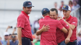 Scottie Scheffler, Justin Thomas and Jordan Spieth congratulate Xander Schauffele after his victory secured The Presidents Cup for the United States