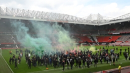 Manchester United supporters on the pitch at Old Trafford