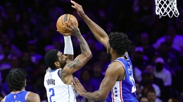 Kyrie Irving attempts a lay up past Joel Embiid