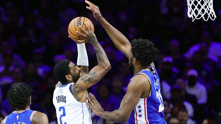 Kyrie Irving attempts a lay up past Joel Embiid