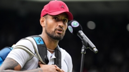 Nick Kyrgios donned a red cap and trainers for his post-match interview