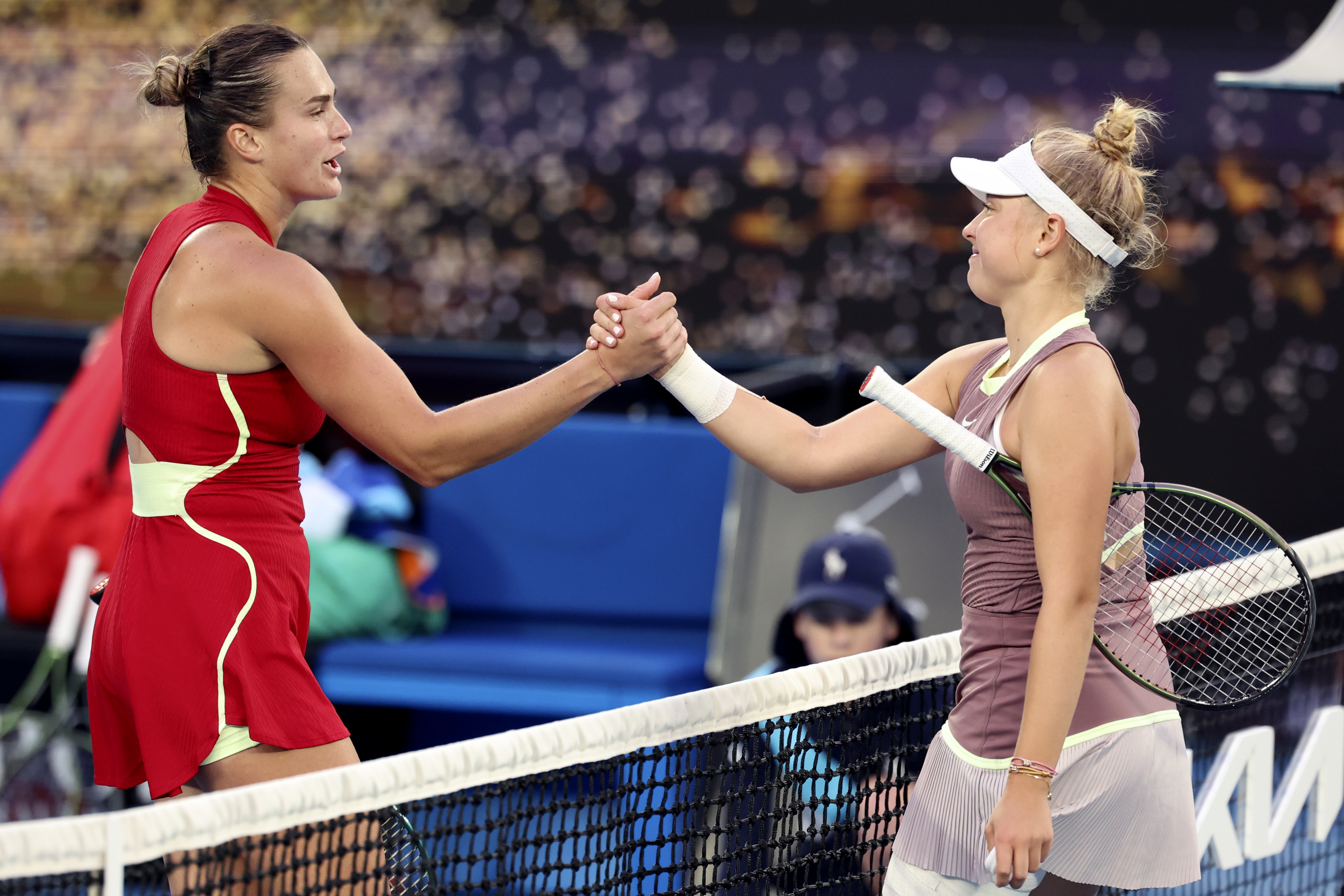 Aryna Sabalenka, left, shakes hands with teenager Brenda Fruhvirtova