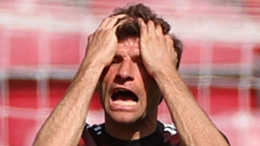 Bayern Munich's Thomas Muller holds his head