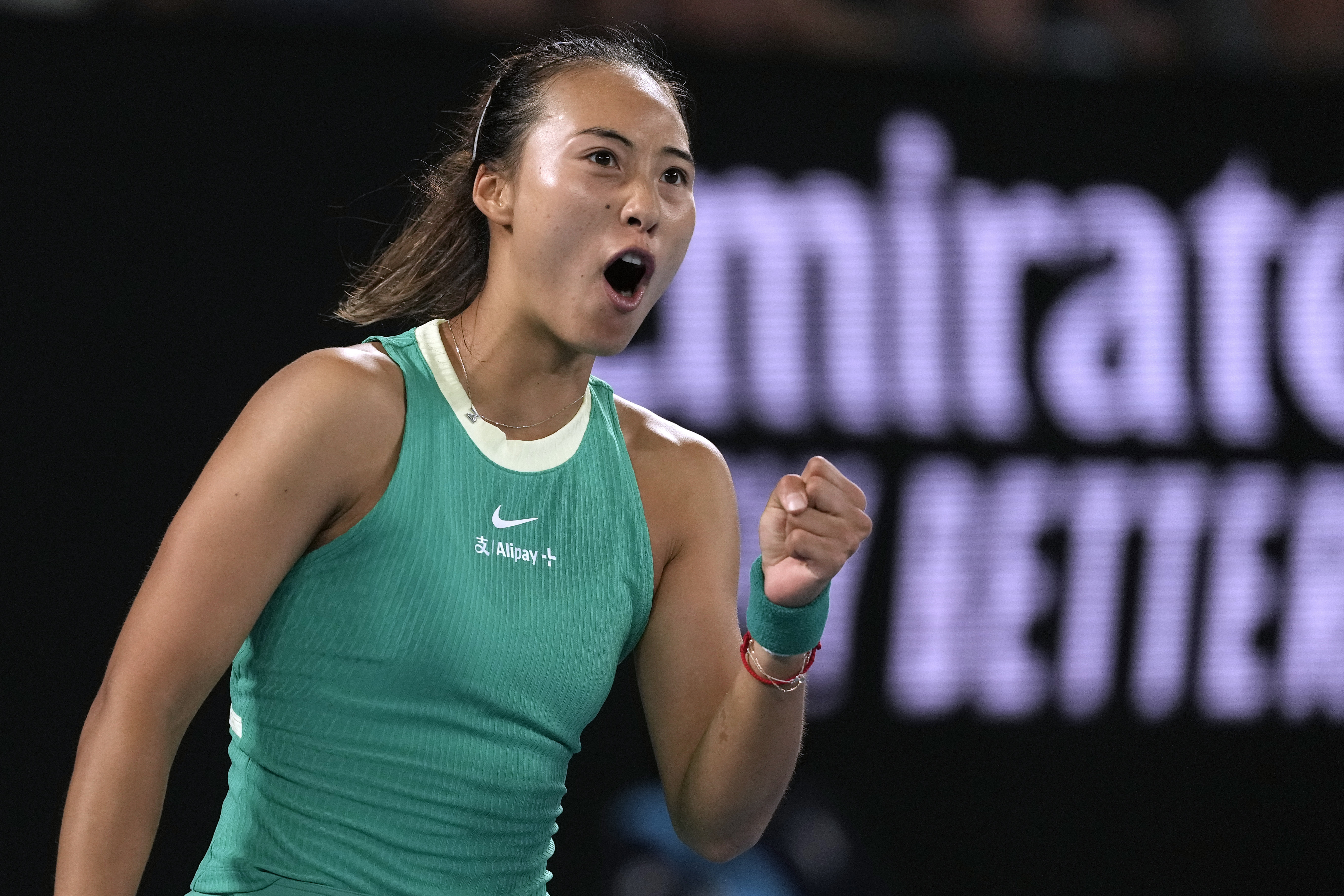 Zheng Qinwen celebrates winning a point against Anna Kalinskaya