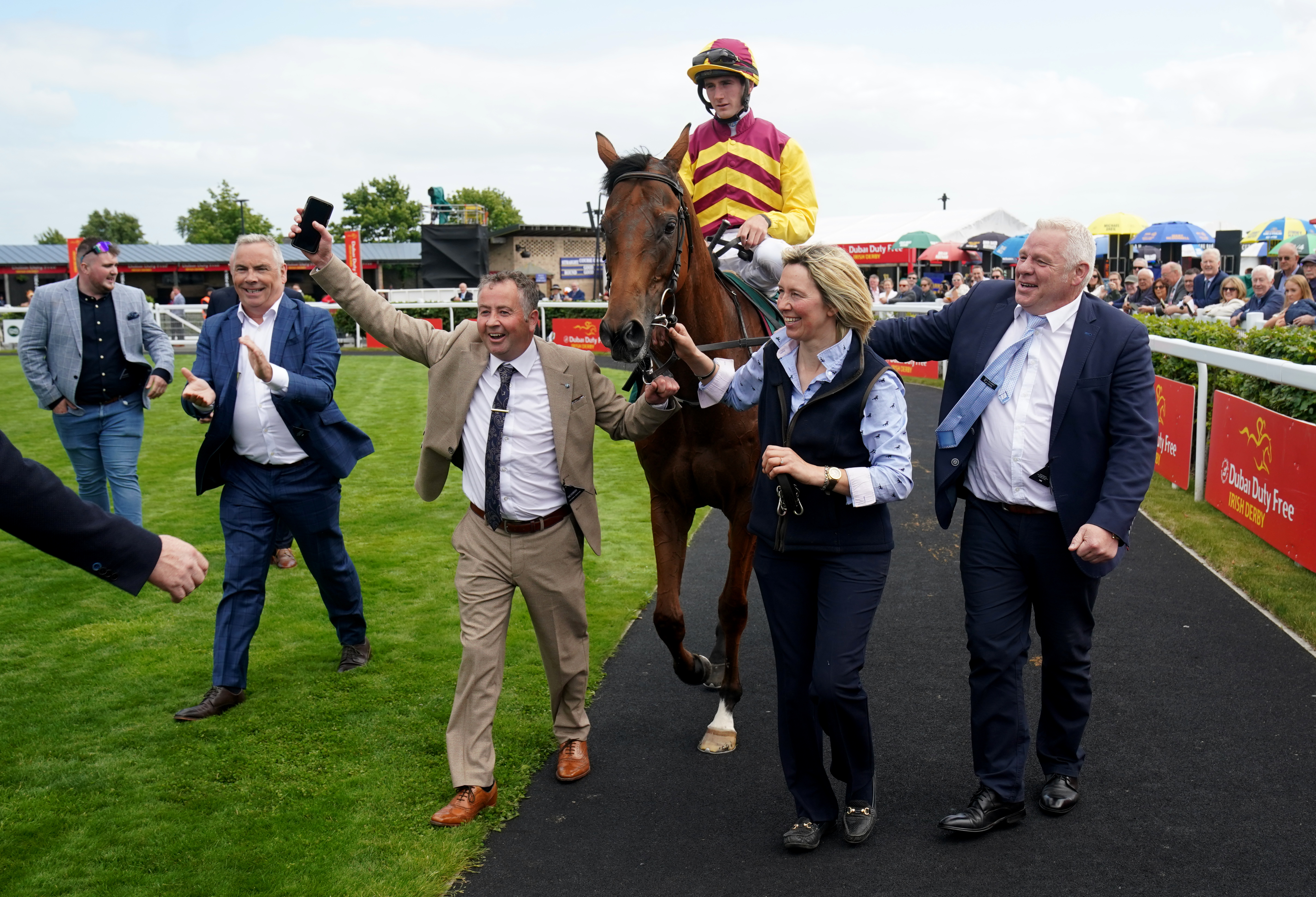 Mashhoor lead into the parade ring by the winning connections after the Paddy Power International Stakes at the Curragh