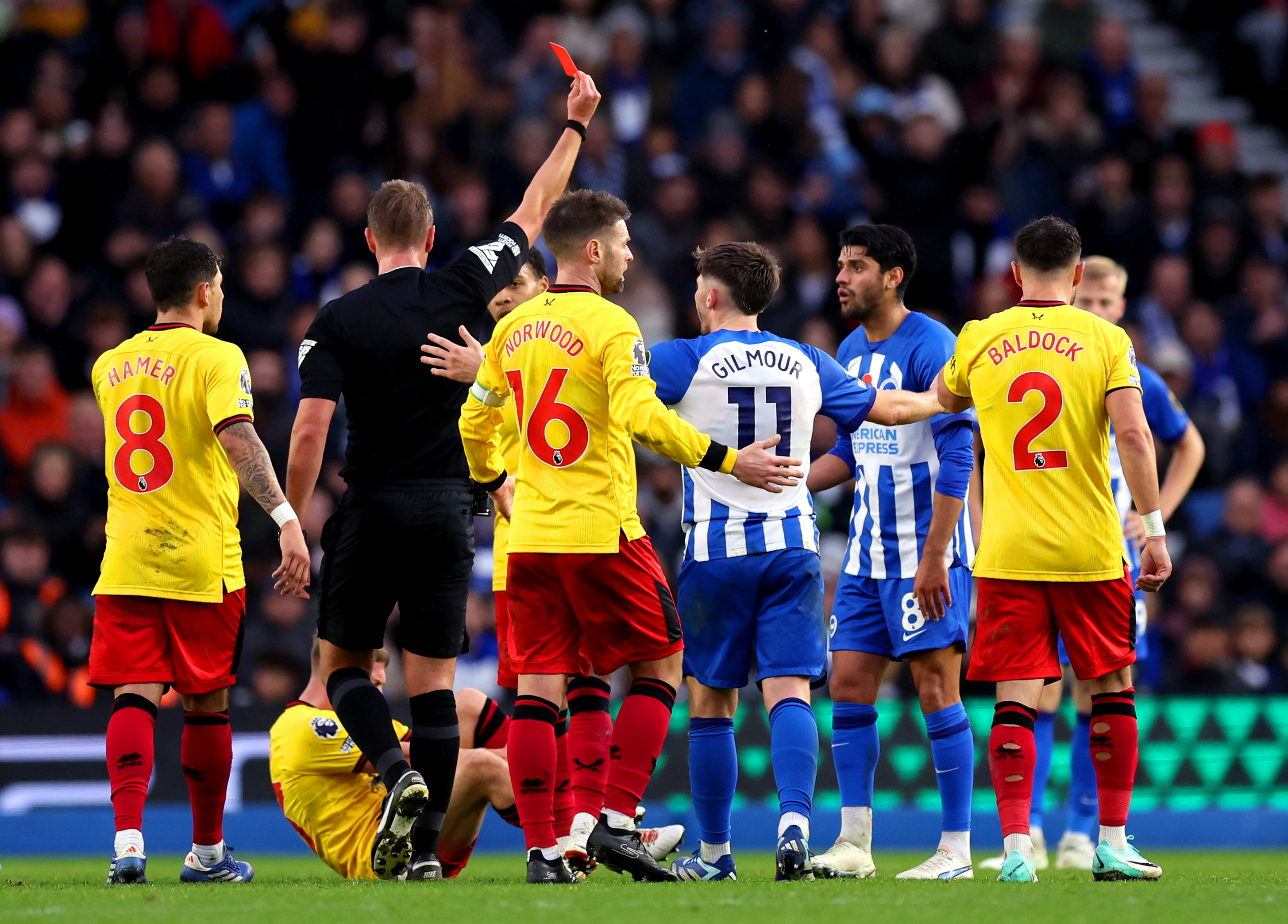 Referee John Brooks, second left, shows a red card to Brighton’s Mahmoud Dahoud, second right