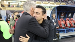 Xavi (R) hugs Carlo Ancelotti ahead of January's Clasico