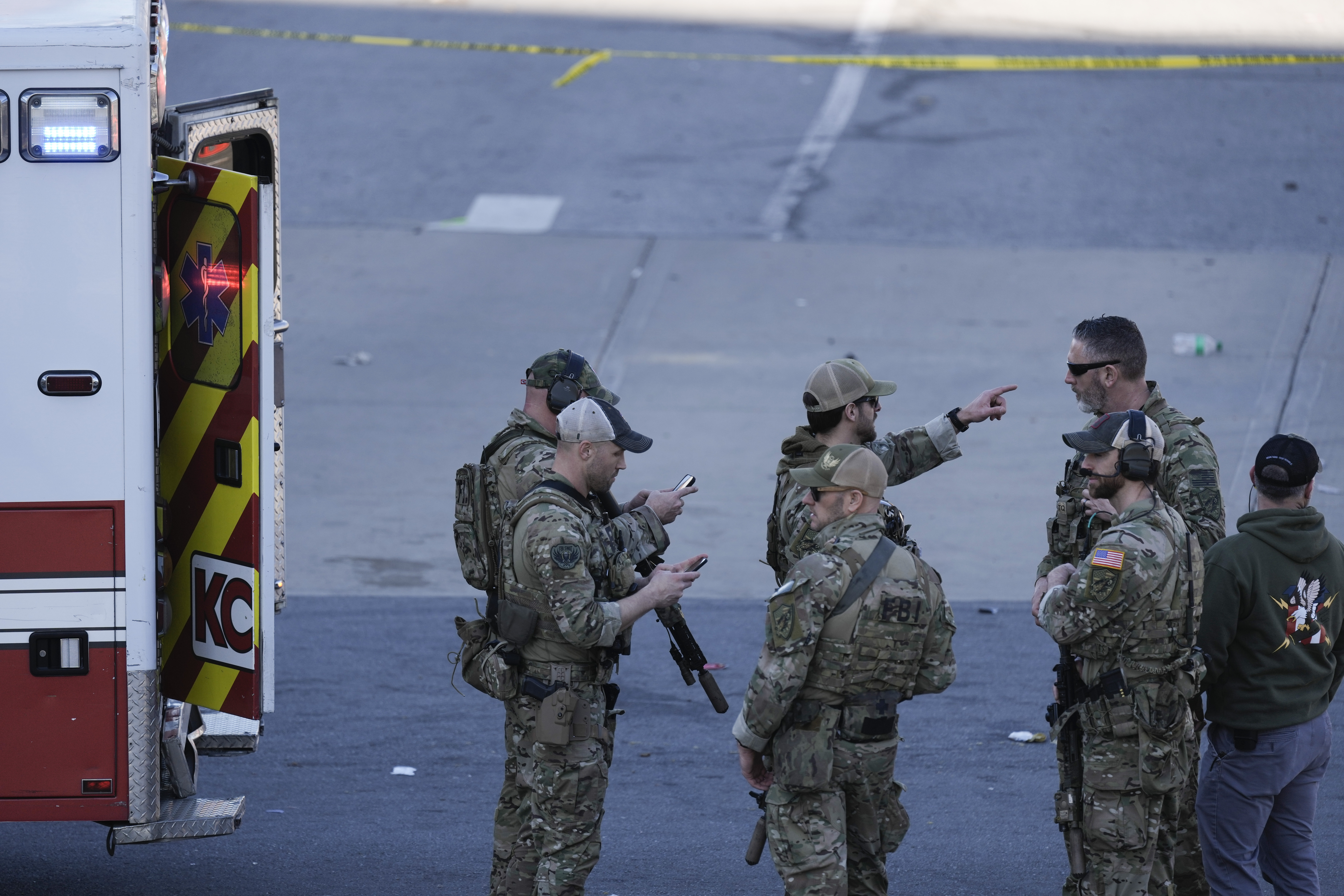 Law enforcement officers arrive at the scene after a shooting at Kansas City Chiefs' parade