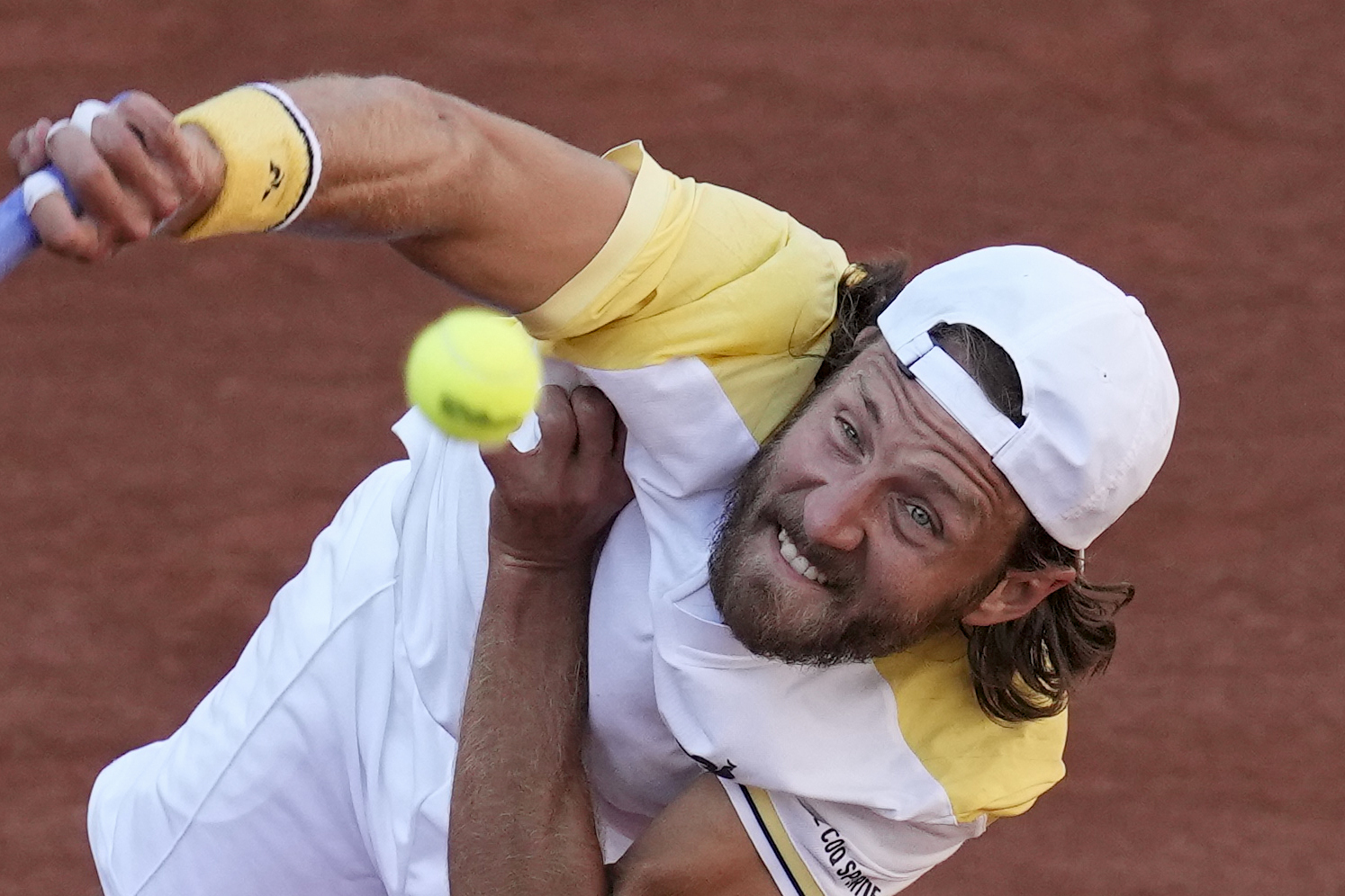 Franceโs Lucas Pouille hits a serve