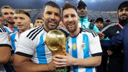 Sergio Aguero (L) and Lionel Messi (R) celebrate with the World Cup trophy after the final in Qatar