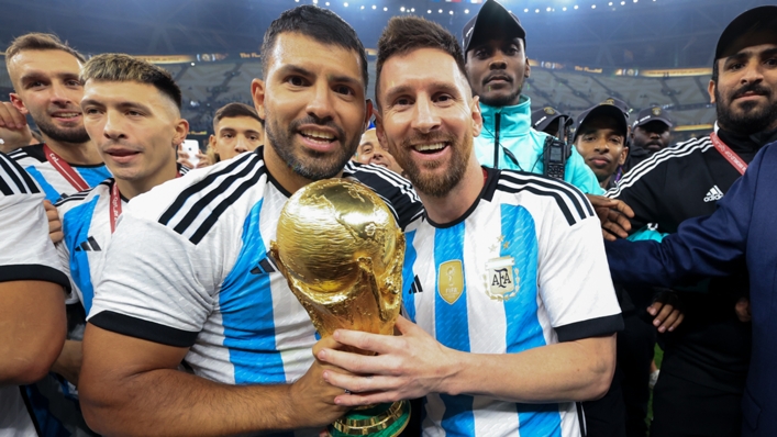 Sergio Aguero (L) and Lionel Messi (R) celebrate with the World Cup trophy after the final in Qatar