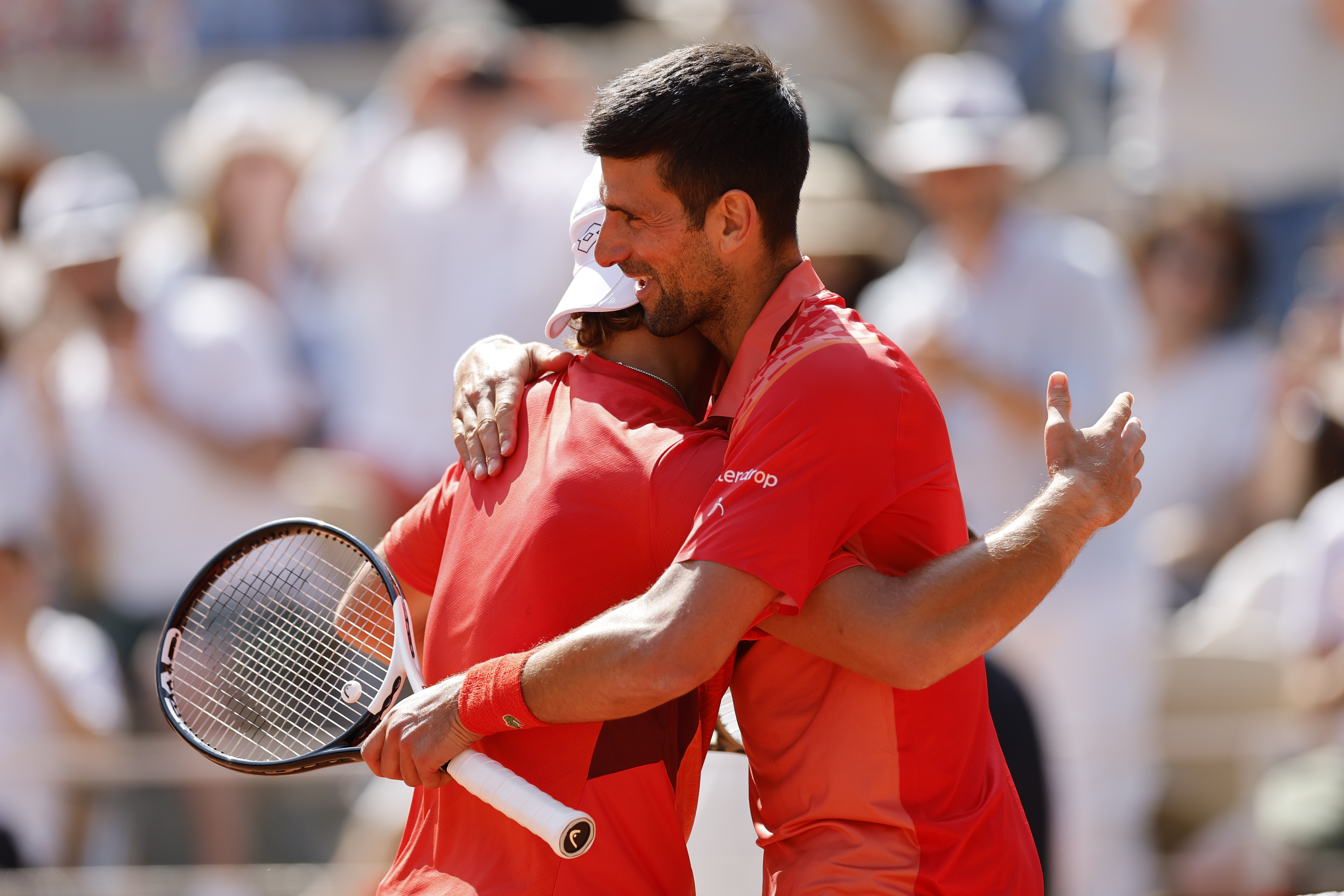 Novak Djokovic embraces Aleksandar Kovacevic after their French Open clash