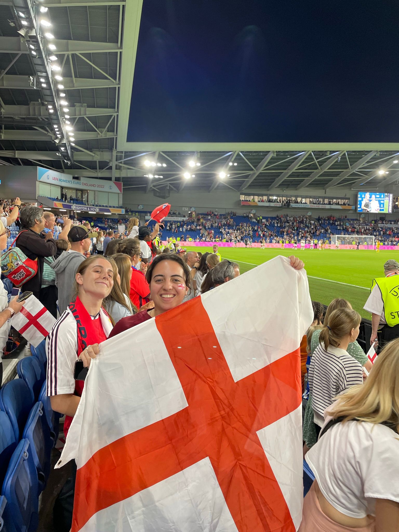Layana Sasieddine holding an England flag during a football match in the Euros