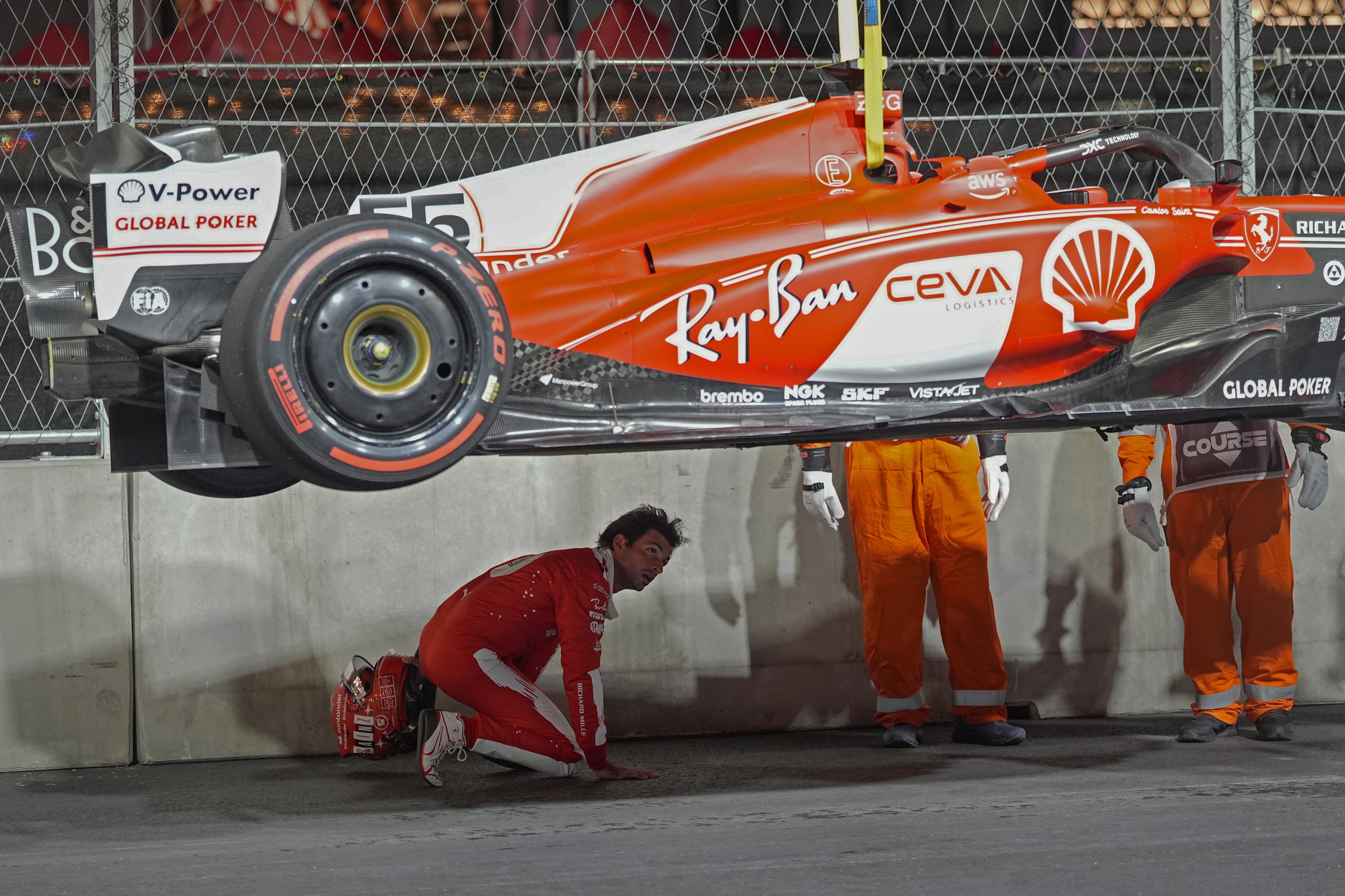 Carlos Sainz inspects his Ferrari