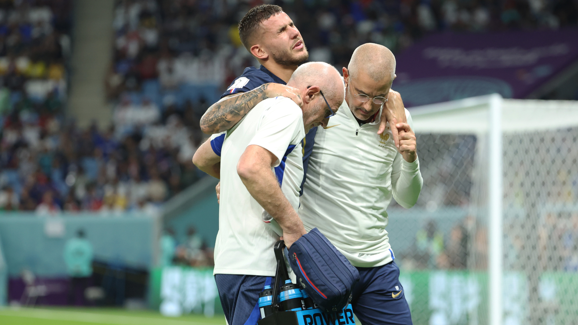 Lucas Hernandez being helped off the field after rupturing his ACL against Australia