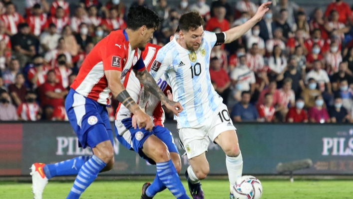 Lionel Messi (R) in action against Paraguay