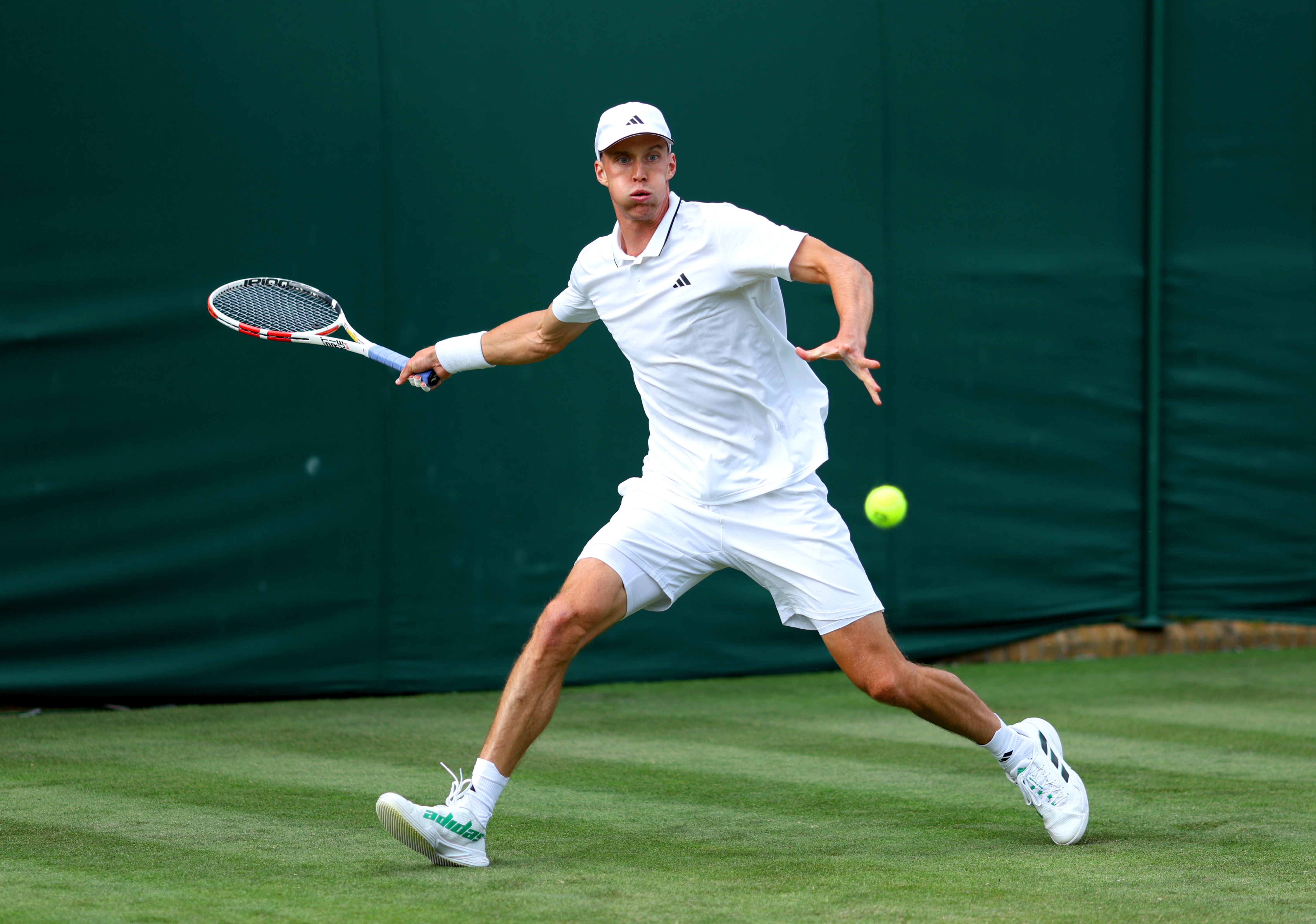 Jan Choinski returns a ball during his win at Wimbledon