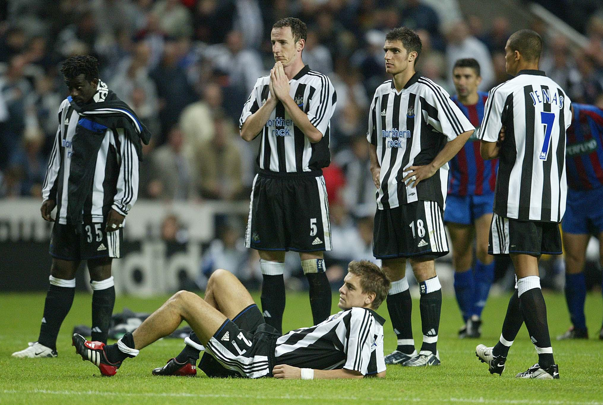 Newcastle’s Jonathan Woodgate (on floor) and his team-mates reflect on their penalty shoot-out defeat by Partizan Belgrade